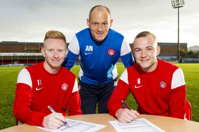 Alex Neil (centre) joins Ali Crawford (left) and Grant Gillespie as they sign a new four year contract with the club. Picture: SNS
