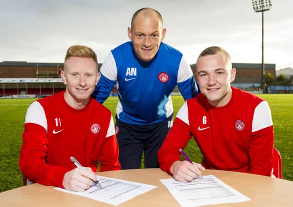 Alex Neil (centre) joins Ali Crawford (left) and Grant Gillespie as they sign a new four year contract with the club. Picture: SNS