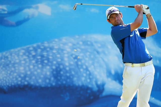 Peter Whiteford tees off in front of an eyecatching advertising billboard at the fifth hole. Picture: Getty