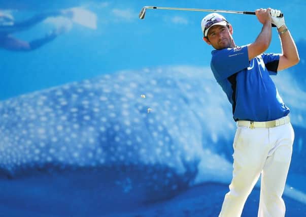 Peter Whiteford tees off in front of an eyecatching advertising billboard at the fifth hole. Picture: Getty