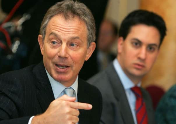 Former Prime Minister Tony Blair gestures towards Labour party leader Ed Miliband, the man he insists 'can and will' win the general election. Picture: PA