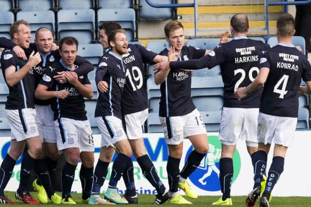 The Dundee players go wild after Greg Stewart (3rd right) doubled their lead. Picture: SNS