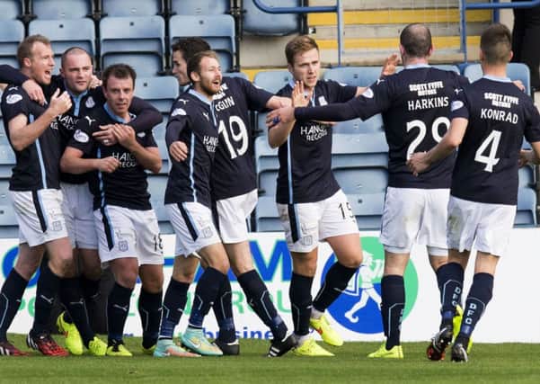 The Dundee players go wild after Greg Stewart (3rd right) doubled their lead. Picture: SNS