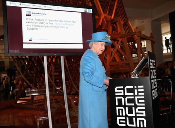 Queen Elizabeth II sends her first tweet at the Science Museum in London. Picture: AFP