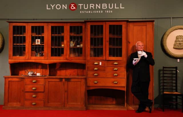 Sidney Drew of Lyon & Turnbull with Mackintosh kitchen that is to be auctioned off. Picture: JP