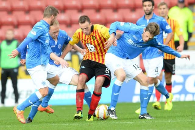 Thistle's Stuart Bannigan holds off Murray Davidson (right) and Steven Anderson (left). Picture: SNS