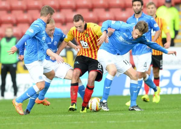 Thistle's Stuart Bannigan holds off Murray Davidson (right) and Steven Anderson (left). Picture: SNS