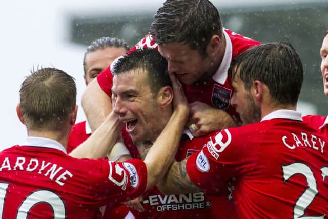 Ross County's Paul Quinn (centre) celebrates having put his side 1-0 to the good. Picture: SNS