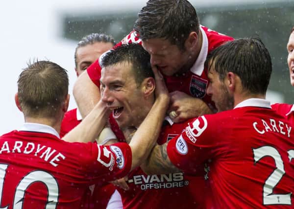 Ross County's Paul Quinn (centre) celebrates having put his side 1-0 to the good. Picture: SNS