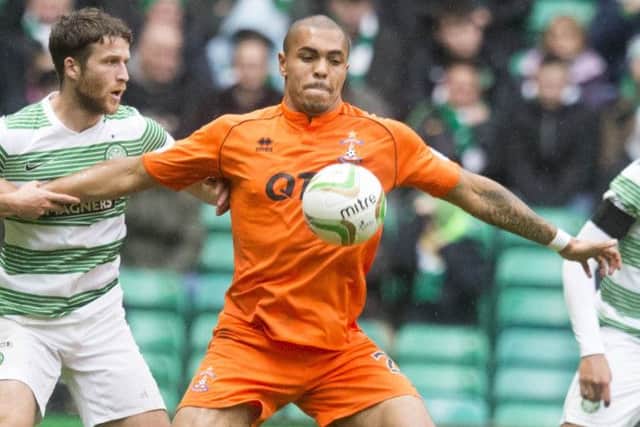 Josh Magennis battles for the ball against Celtic. Picture: PA