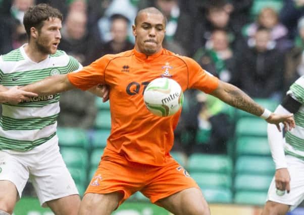 Josh Magennis battles for the ball against Celtic. Picture: PA