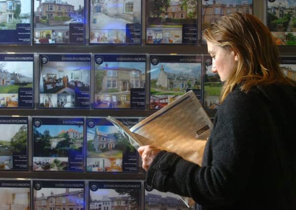 A woman looks at house prices in the ESPC on George Street in Edinburgh. Picture: Dan Phillips