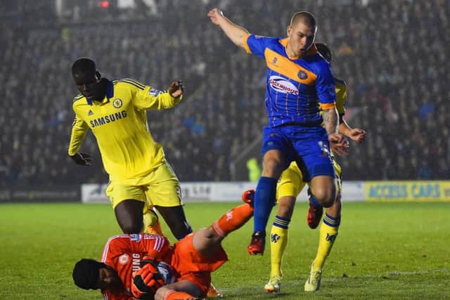 Petr Cech scrambles to save from Shrewsburys former Hibernian striker James Collins. Picture: Getty