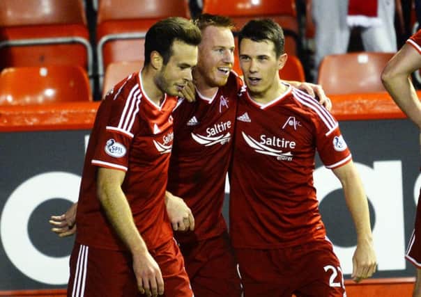 Aberdeen's Adam Rooney (centre) celebrates scoring the game's only goal. Picture: SNS