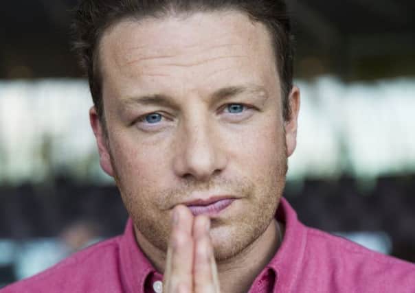 Jamie Oliver did not claim his jollof rice, inset, is authentic but online critics are angry. Picture: Getty
