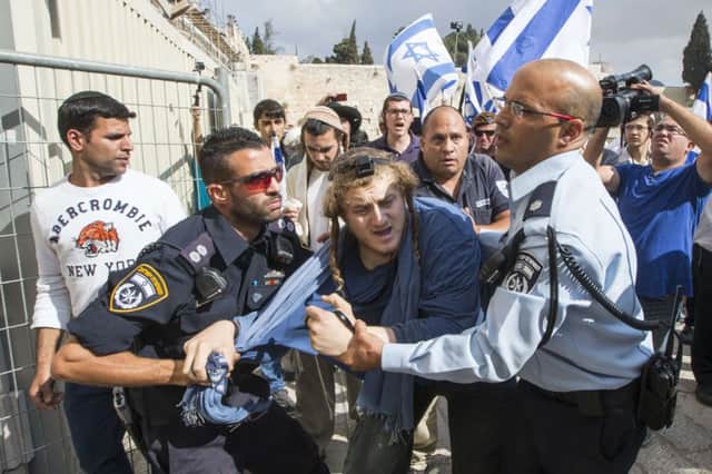 Rightwing Jews are restrained by police at the alAqsa site. Picture: Getty
