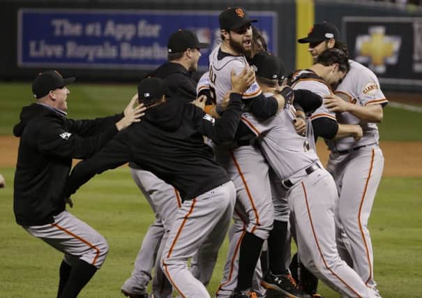Jubilant San Francisco Giants players mob pitcher Madison Bumgarner. Picture: AP