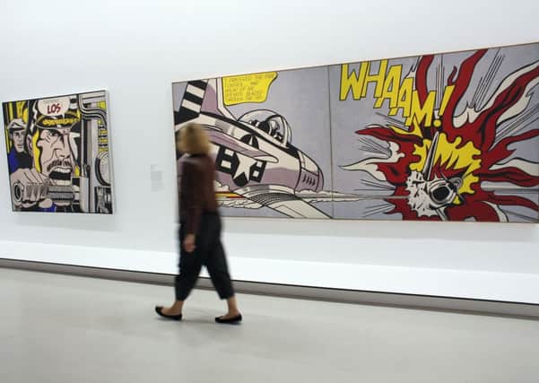 A visitor passes by artworks by late US artist Roy Lichtenstein. Picture: Getty