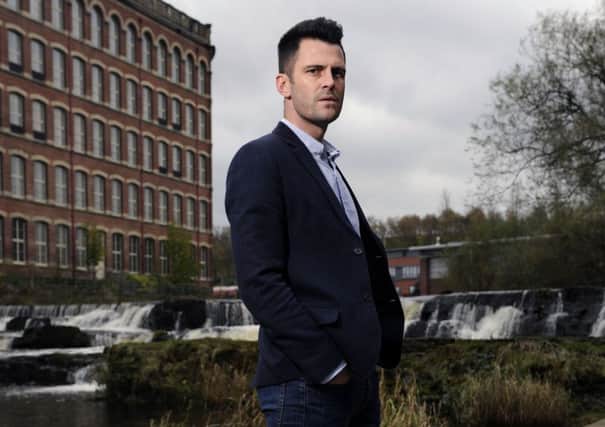 Local lad Steven Thompson stands in front of the iconic Paisley Anchor Mills. Picture: John Devlin