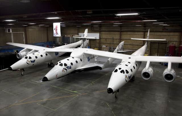 SpaceShipTwo resting under the Mothership WhiteKnight2 inside a hangar in Mojave. Picture: Virgin Galactic