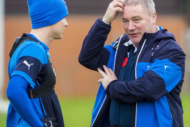 Rangers manager Ally McCoist, speaking here with midfielder Lewis MacLeod at training. Picture: SNS