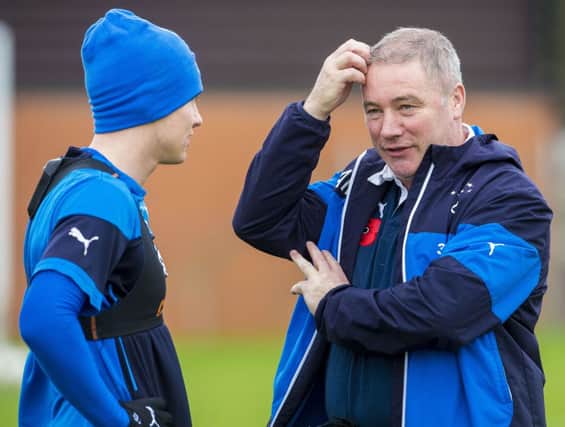 Rangers manager Ally McCoist, speaking here with midfielder Lewis MacLeod at training. Picture: SNS