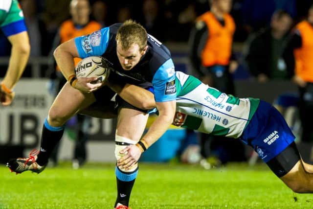 Glasgow Warriors' Chris Fusaro (left) is tackled by Simon Favaro of Treviso. Picture: SNS