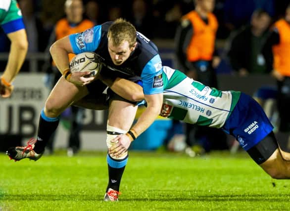 Glasgow Warriors' Chris Fusaro (left) is tackled by Simon Favaro of Treviso. Picture: SNS