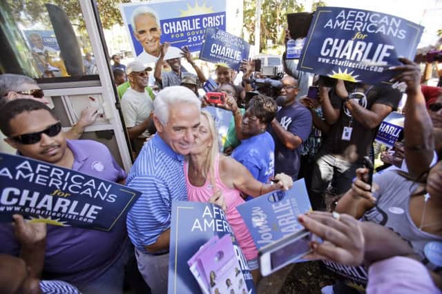 Democratic candidate Charlie Crist gets a kiss in Florida. Picture: AP