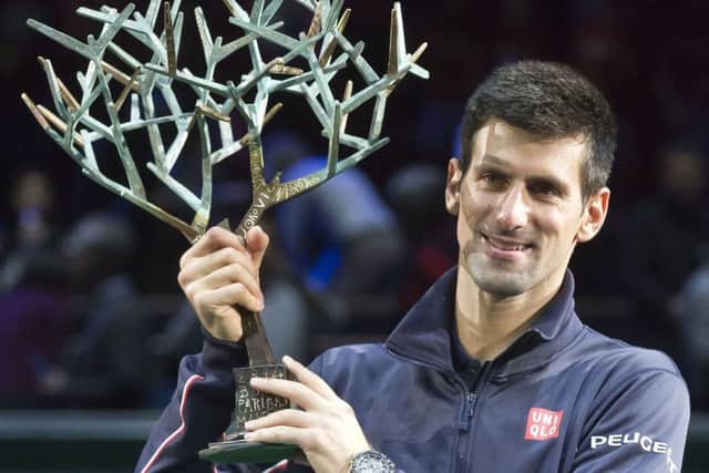 Novak Djokovic with the trophy after beating Milos Raonic in Paris yesterday. Picture: AP