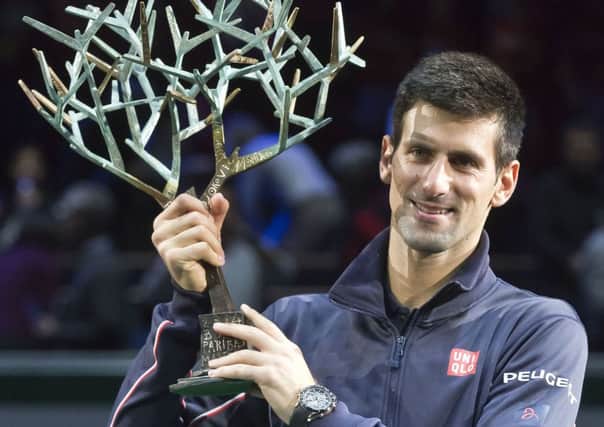 Novak Djokovic with the trophy after beating Milos Raonic in Paris yesterday. Picture: AP