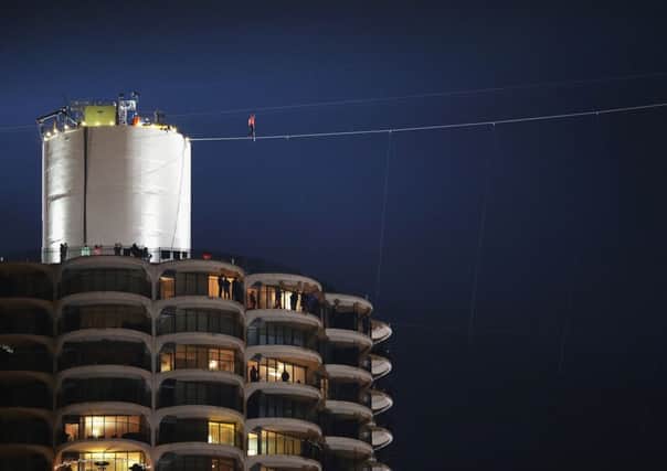 Nik Wallenda starts out on his wire walk from Marina City's west tower to the Leo Burnett building. Picture: Getty