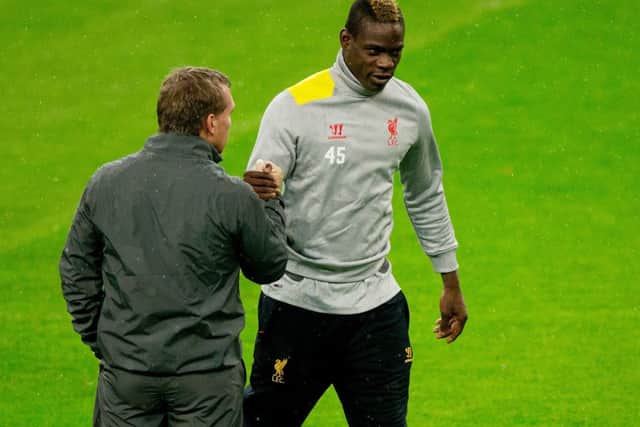 Brendan Rodgers shakes hands with his player Mario Balotelli (R) during training. Picture: Getty