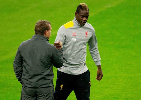 Brendan Rodgers shakes hands with his player Mario Balotelli (R) during training. Picture: Getty