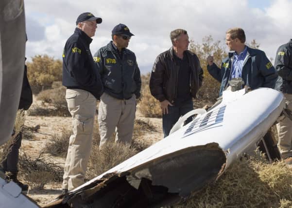 NTSB Acting Chairman Christopher Hart(2nd-L) with Virgin Galactic pilot Todd Ericson(C) and investigators surveying one section of the SpaceShipTwo accident site. Picture: Getty