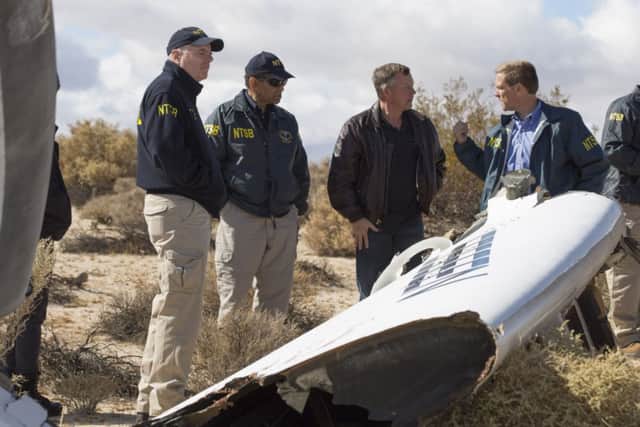 NTSB Acting Chairman Christopher Hart(2nd-L) with Virgin Galactic pilot Todd Ericson(C) and investigators surveying one section of the SpaceShipTwo accident site. Picture: Getty