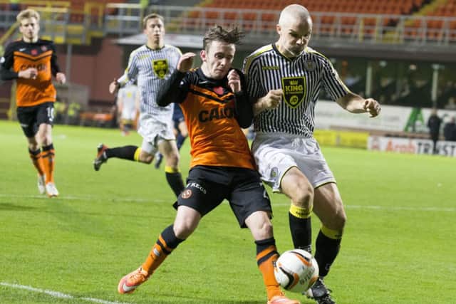 Jim Goodwin tussles with United's Aidan Connolly during the match at Tannadice. Picture: SNS