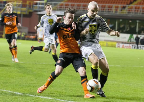 Jim Goodwin tussles with United's Aidan Connolly during the match at Tannadice. Picture: SNS