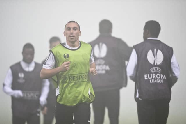 Scott Brown warms up in heavy fog as the Celtic players were put through their paces in Romania. Picture: AP