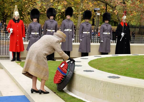 Queen Elizabeth II places a wreath of poppies at the new Flanders Field Memorial. Picture: Getty