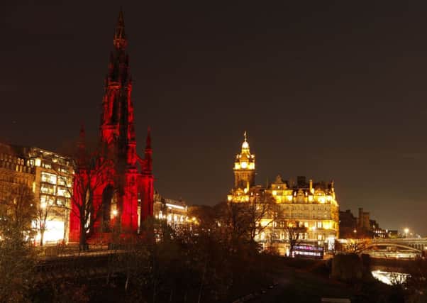 The Scott Monument in bathed in poppy red to pay tribute to those who lost their lives in World War One. Picture: Tony Williamsa