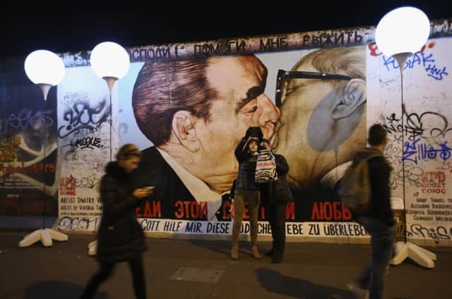 A mural of former Soviet leader Leonid Brezhnev kissing former East German leader Erich Honecker on an original section of the Berlin Wall. Picture: Getty