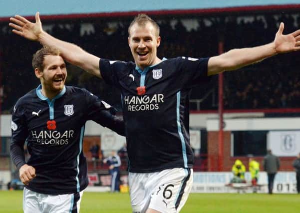 Dundee's David Clarkson (right) celebrates after opening up the scoring for his side. Picture: SNS