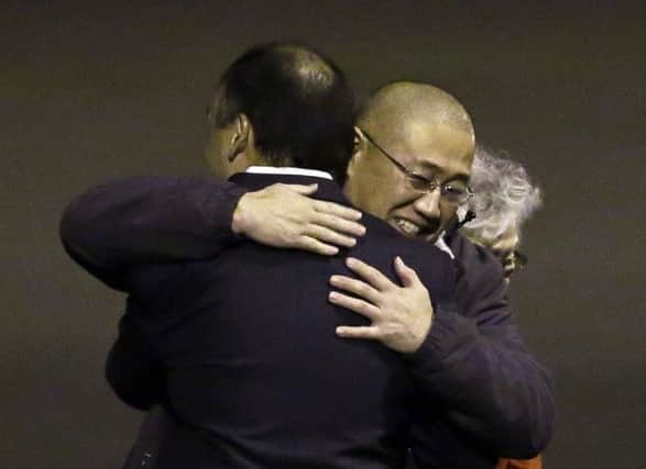 Kenneth Bae is hugged by family members after arriving back on US soil. Picture: AP