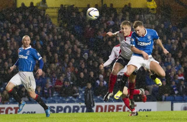 On-form Rangers midfielder Lewis Macleod, right, heads home his sides second goal against Falkirk. Picture: SNS