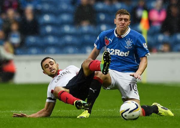 Lewis Macleod keeps Falkirk's Tom Taiwo at bay. Picture: SNS