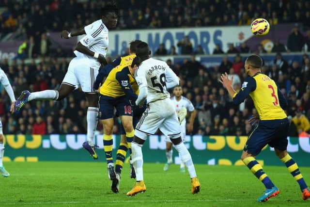 Swansea substitute Bafetimbi Gomis climbs above the Arsenal defence in the 78th minute to head home. Picture: Getty