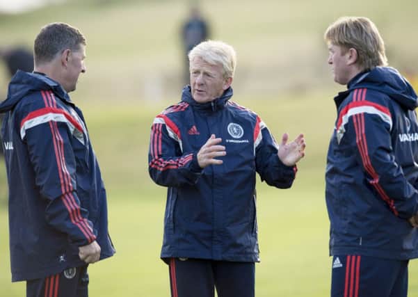 Scotland assistants Mark McGhee and Stuart McCall listen to manager Gordon Strachan during a training session. Picture: PA