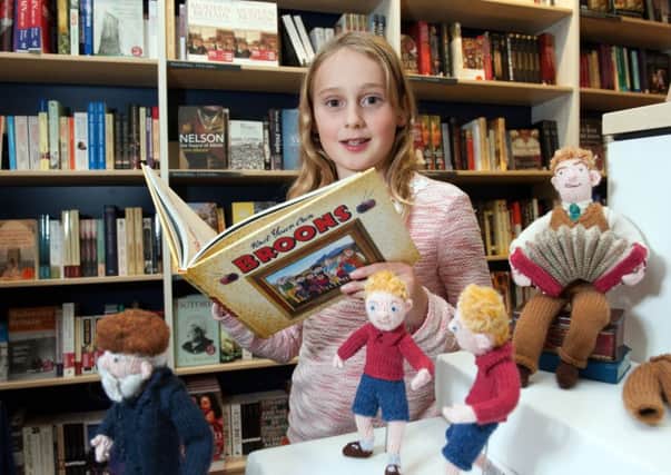 Flora Henry, 10, from Portobello, Edinburgh gets a look at the new book in the company of some knitted Broons. Picture: Andrew Brown