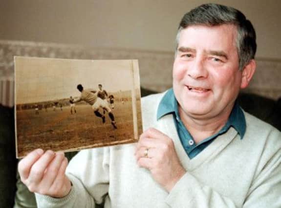 Sammy Reid, pictured in 1997, holding a photo of his famous Scottish Cup moment. Picture: SNS